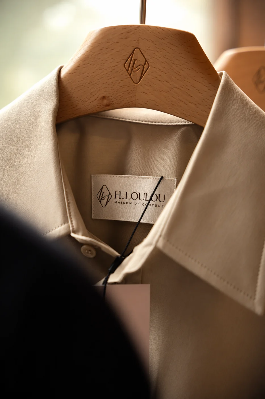 Illustrative garment collar on a wooden hanger in natural light