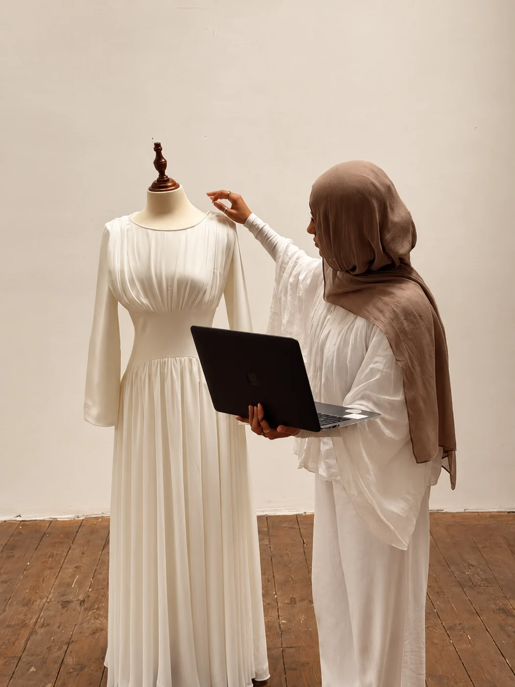 Illustrative scene of a tailor fitting a long white dress on a form